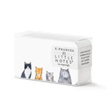 E. Frances stationery product photography of a white box of 85 Little Notes featuring a charming illustration of four diverse cats including a black and white tuxedo and an orange tabby alongside text mentioning Lunch Box Love and Pocket Notes