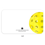 Digital illustration by E. Frances Paper of a vibrant yellow pickleball with many holes, partially visible on a white rounded note card back featuring the brand's smiley logo and 'PLEASE RECYCLE ME' text