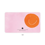 Paper note by E. Frances Paper, its back featuring a pink watercolor background and a large vibrant orange minimalist smiley face with white dot eyes and a curved smile, includes text Little Notes by E. Frances Paper Please Recycle Me and a small E.F. logo