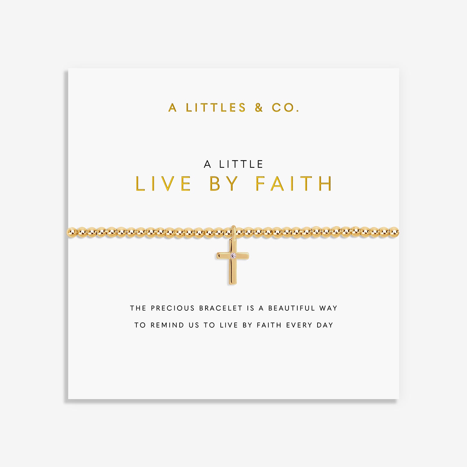 Gold beaded bracelet with a cross charm on a display card reading A Little Live By Faith