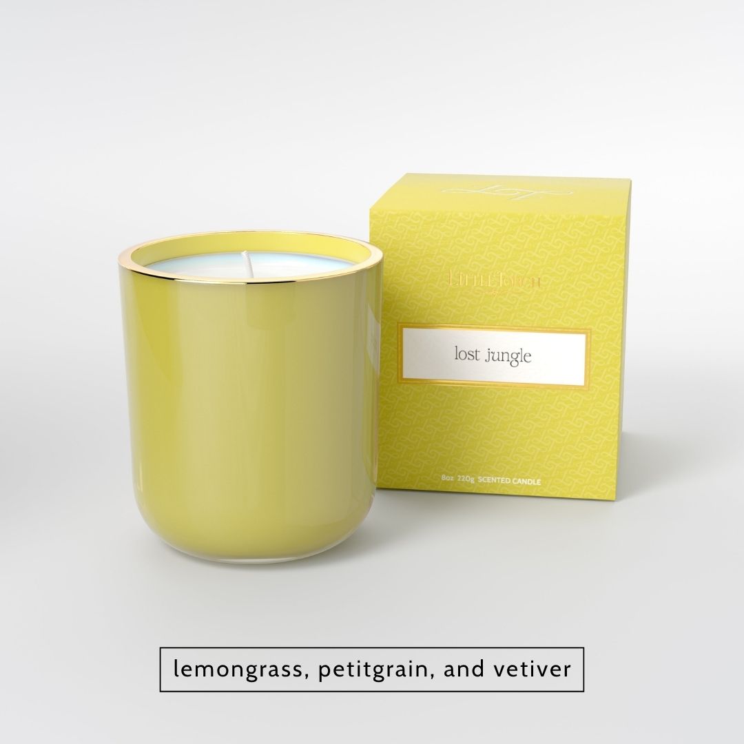 Yellow scented candle in a glass jar with matching box labeled lost jungle