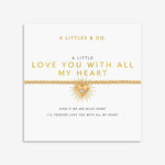 Gold beaded bracelet with a sunburst heart charm on a display card
