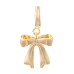 Gold charm, a shiny gold bow design with a folded ribbon appearance and a top bail for attachment isolated against a white background