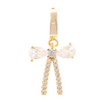 Gold-toned bow charm with two brilliant teardrop cubic zirconia stones and pavé-set round stones forming a V-design
