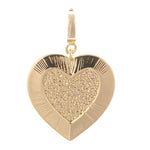 Gold heart-shaped pendant featuring a granulated textured inner heart and smooth radiating lines on its outer border attached to a small bail