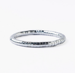 A metallic grey segmented flexible bracelet with a glossy finish on a clean white background