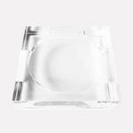 Clear acrylic square dish with a deep circular indentation, featuring a minimalist design, transparent material and subtle reflective highlights