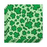 Stack of paper napkins featuring a vibrant St Patrick's Day pattern of various sized dark green shamrocks against a lighter green background
