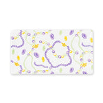 Decorative white rectangular tray featuring a colorful Mardi Gras pattern of purple, green, and gold beads, scattered coins, and small golden crown charms
