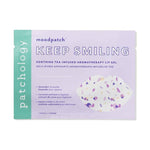 Patchology Moodpatch Keep Smiling Soothing Tea-Infused Aromatherapy Lip Gel product packaging featuring lavender, coconut, and sweet violet extracts in pale purple and mint green hues, with a lip-shaped mask cutout showing vibrant purple and white speckles
