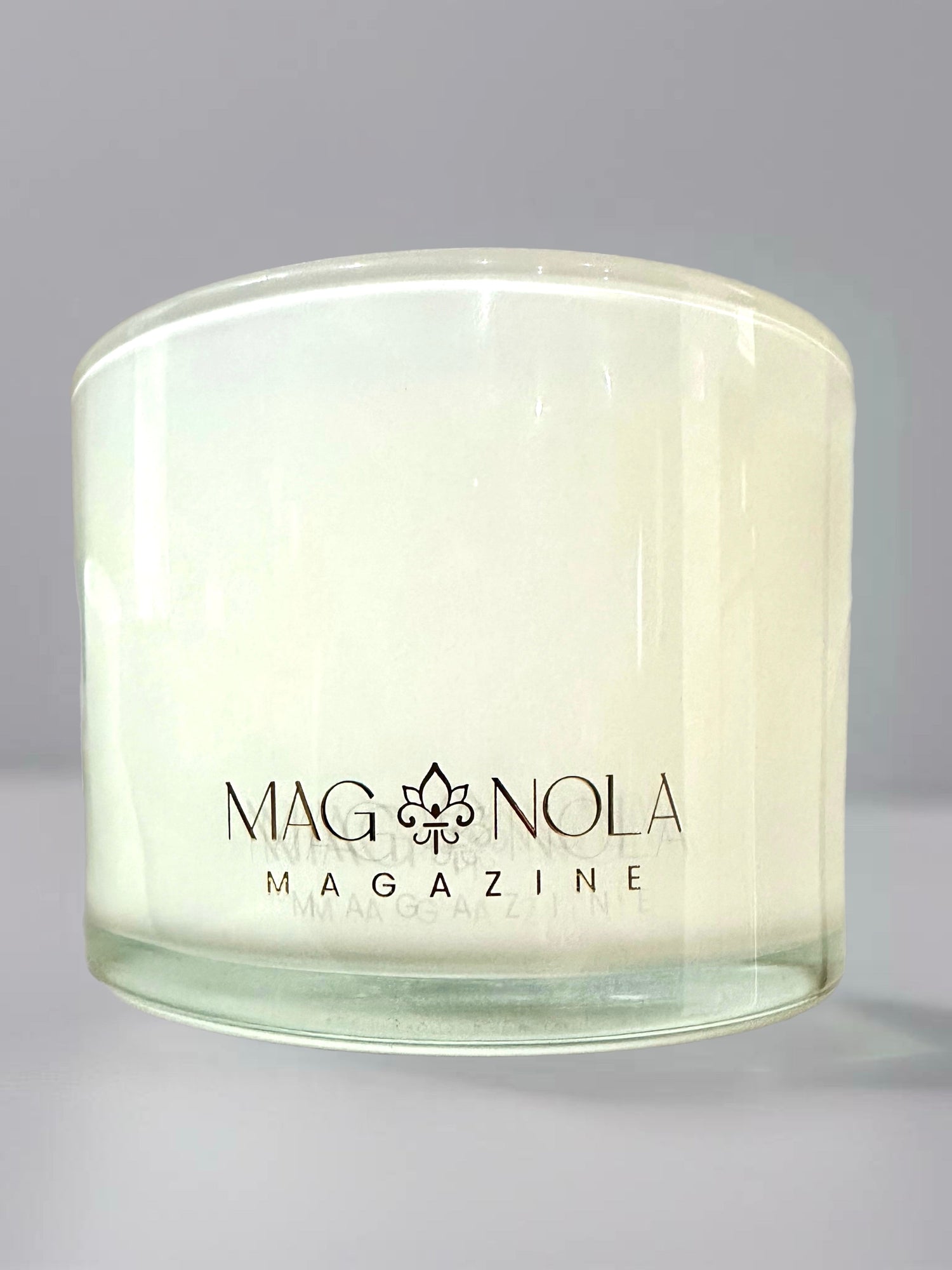 Clear glass candle jar with Magnolia Magazine logo printed on the front