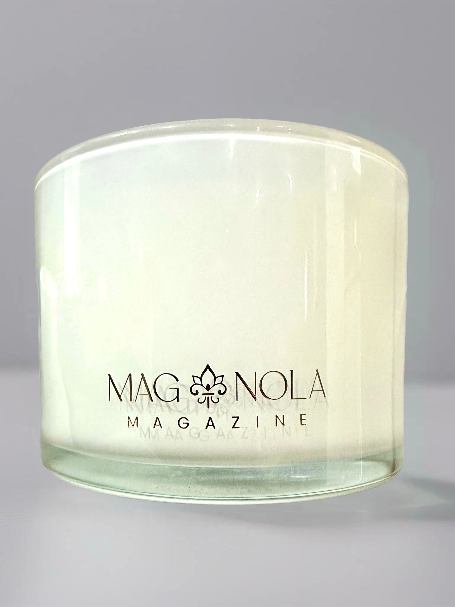 Clear glass candle jar with Magnolia Magazine logo printed on the front