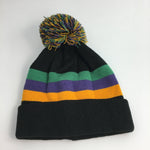 Knit beanie hat with a black base, featuring horizontal green, purple, and gold stripes, and topped with a multi-colored yarn pom-pom