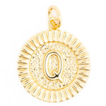 Golden circular pendant featuring a prominent letter Q, with a hammered texture center and a distinct fluted border