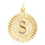 Gold pendant featuring a round initial S in shiny yellow gold with a textured center, radiant fluted border, and polished bail