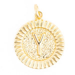Gold-toned round initial pendant featuring a raised capital letter Y on a hammered-texture center with a ridged sunburst edge