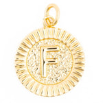 Gold metal charm featuring a prominent letter F with a textured hammered inner circle and a fluted rayed border