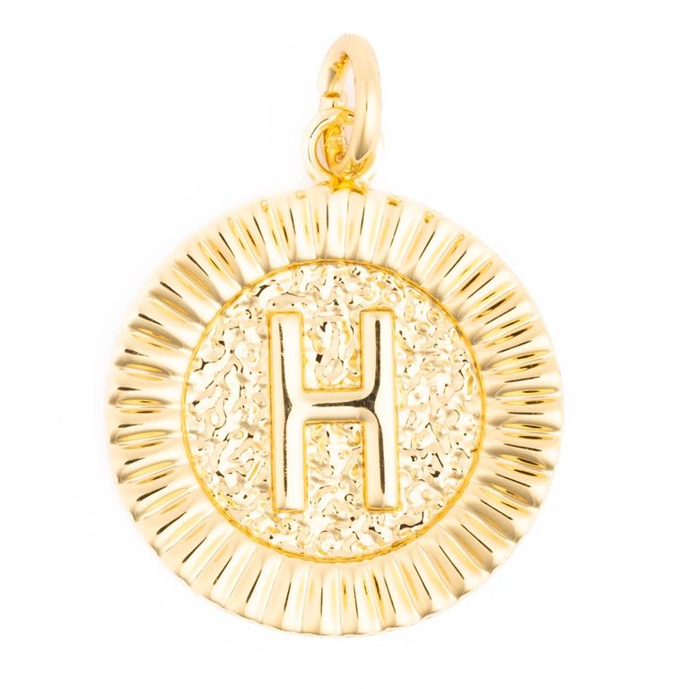 Gold circular pendant featuring a prominent embossed letter H against a hammered texture background and a fluted border