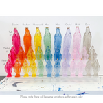 Collection of glass Virgin Mary statues in various colors and sizes arranged on a clear display stand
