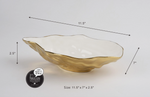 Pampa Bay porcelain serving bowl with wavy organic shape shiny white interior textured metallic gold exterior measuring 11.5 by 7 by 2.5 inches