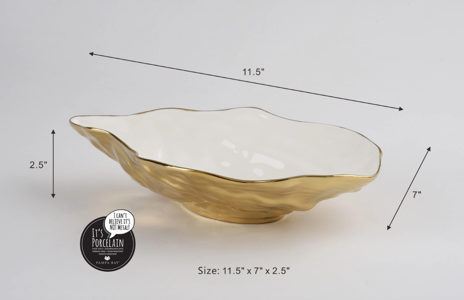 Pampa Bay porcelain serving bowl with wavy organic shape shiny white interior textured metallic gold exterior measuring 11.5 by 7 by 2.5 inches