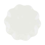 White object with a distinct scalloped edge and subtle shadows viewed from directly above