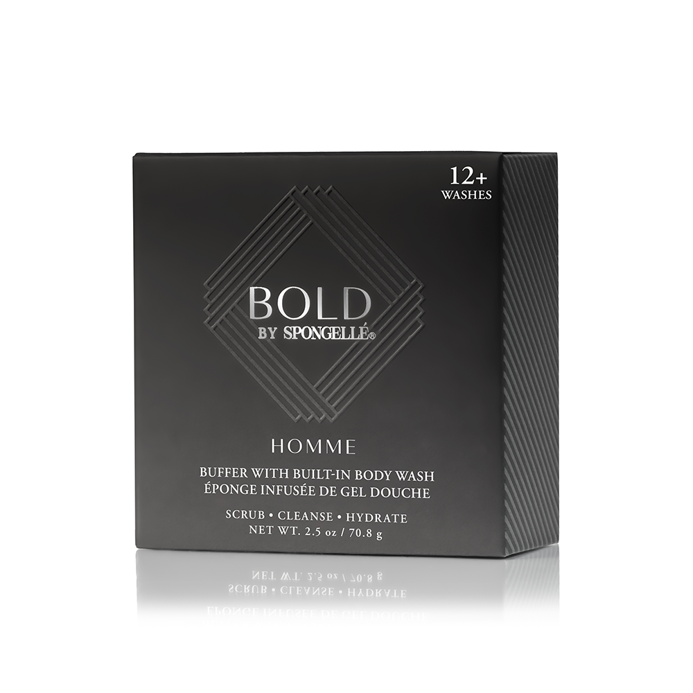 A sleek black Spongellé Homme Buffer with Built-in Body Wash box featuring an embossed BOLD logo, "12+ washes", and "scrub cleanse hydrate" text reflected on a white surface