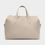 Product photography of a KATE LOUISE light beige textured faux leather duffel bag featuring a gold tone top zipper, twin carry handles, and embossed KATE LOUISE logo