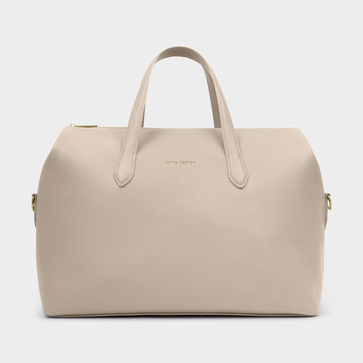 Product photography of a KATE LOUISE light beige textured faux leather duffel bag featuring a gold tone top zipper, twin carry handles, and embossed KATE LOUISE logo