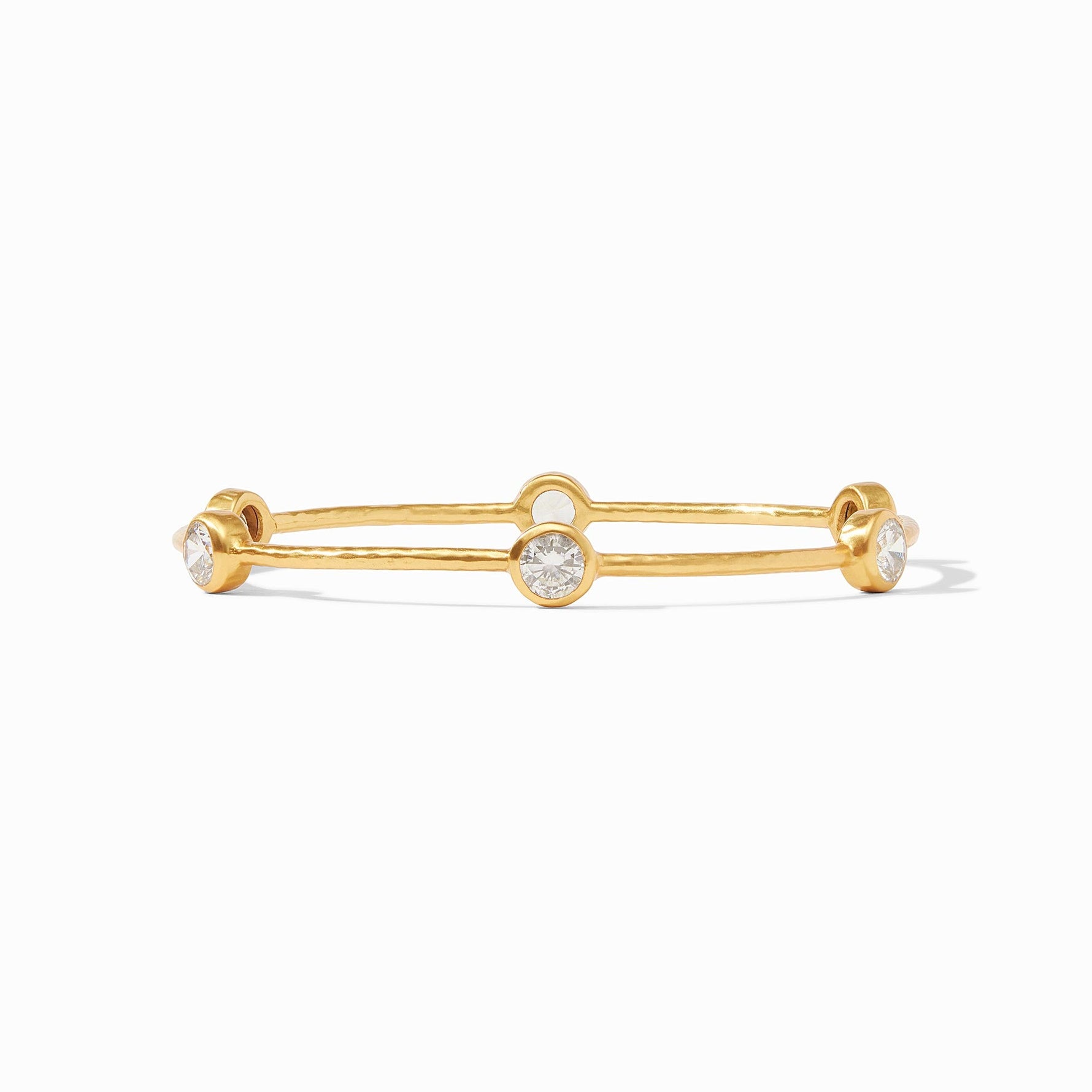 Gold bangle bracelet with three round bezel set clear stones