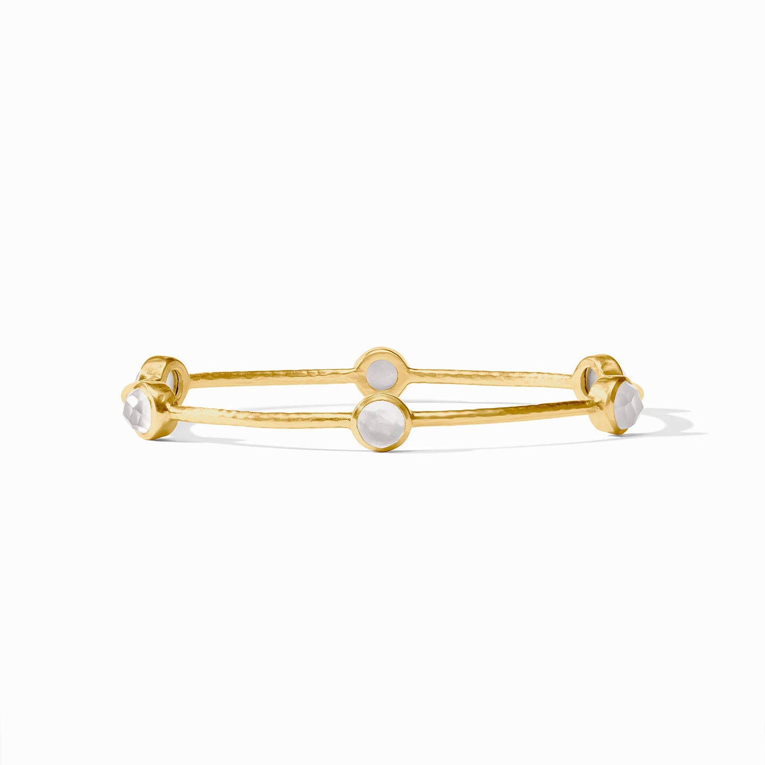 Gold bangle bracelet with four round white stone settings