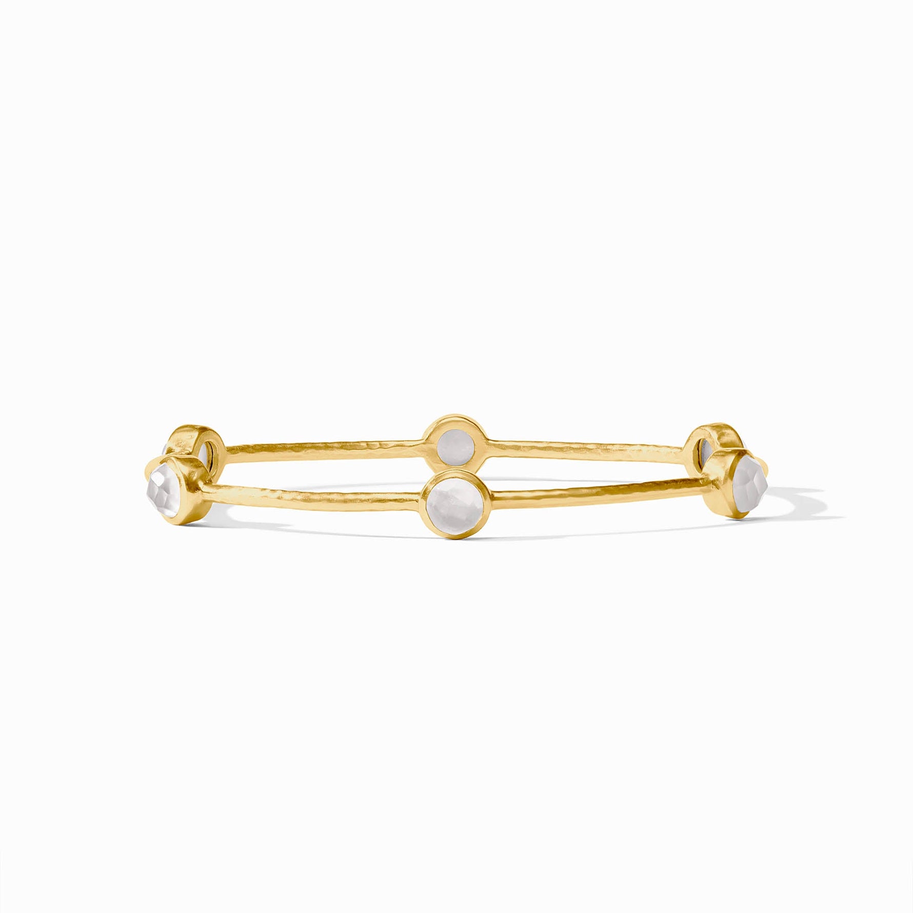 Gold bangle bracelet with four round white stone settings