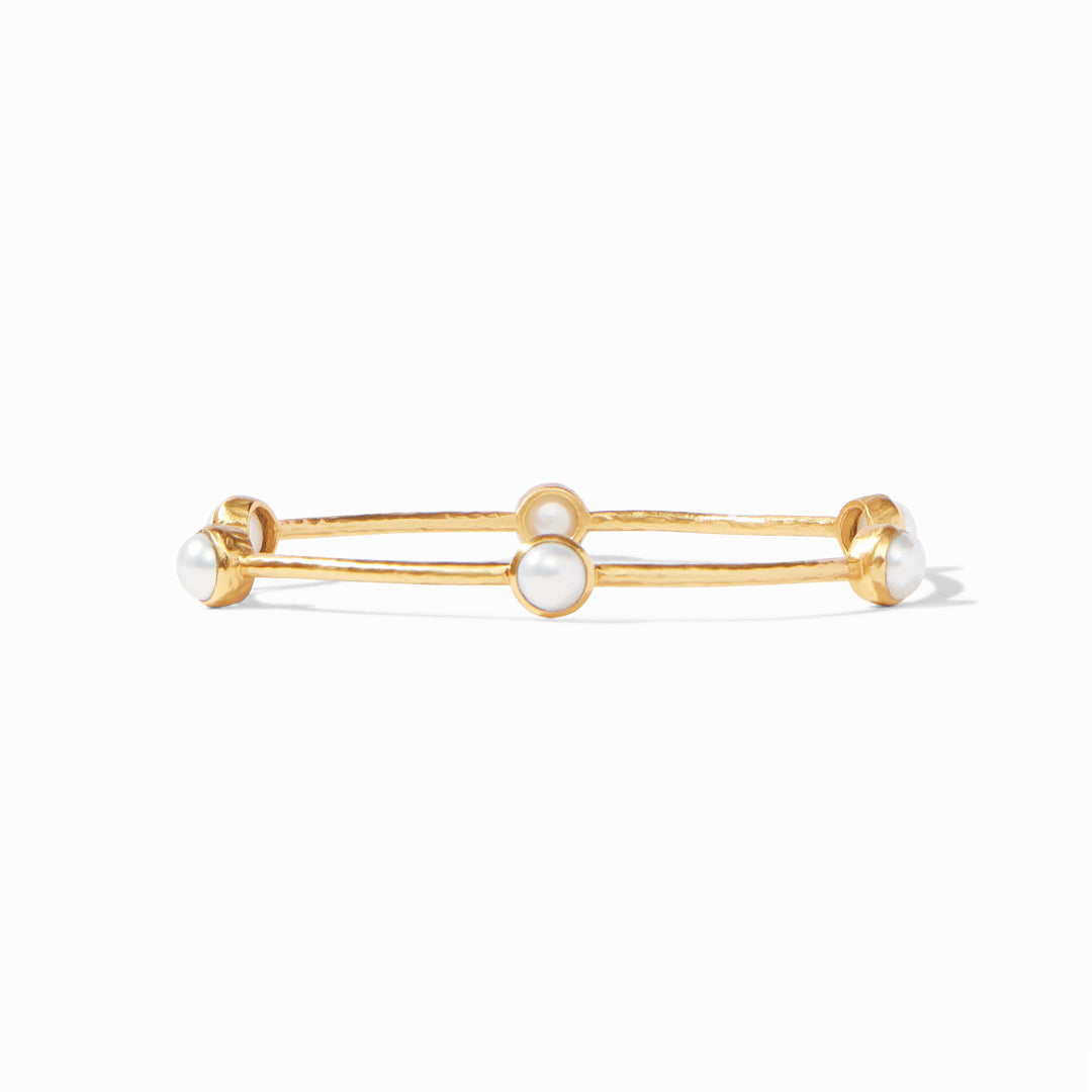 Gold bangle bracelet featuring three evenly spaced white pearls