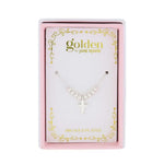 Product image by Golden by JANE MARIE of a silver-toned beaded chain necklace with a cross pendant presented in a pink and white gift box adorned with gold scrollwork and 18K GOLD PLATED text