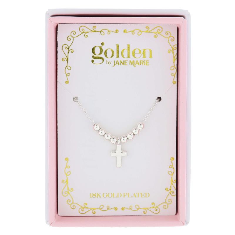 Golden by Jane Marie product photography shows a silver-toned beaded cross necklace with a small cross pendant displayed in a pink and white retail box featuring a gold brand logo, decorative gold scrollwork, and text indicating 18K GOLD PLATED