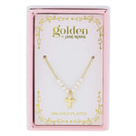 Jane Marie Golden brand 18K gold plated cross necklace with white pearls displayed in a decorative pink and white box with gold scrollwork