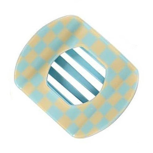 Resin accessory featuring a curved, rounded frame with a light blue and beige checkerboard pattern and a central opening revealing vertical blue and white stripes