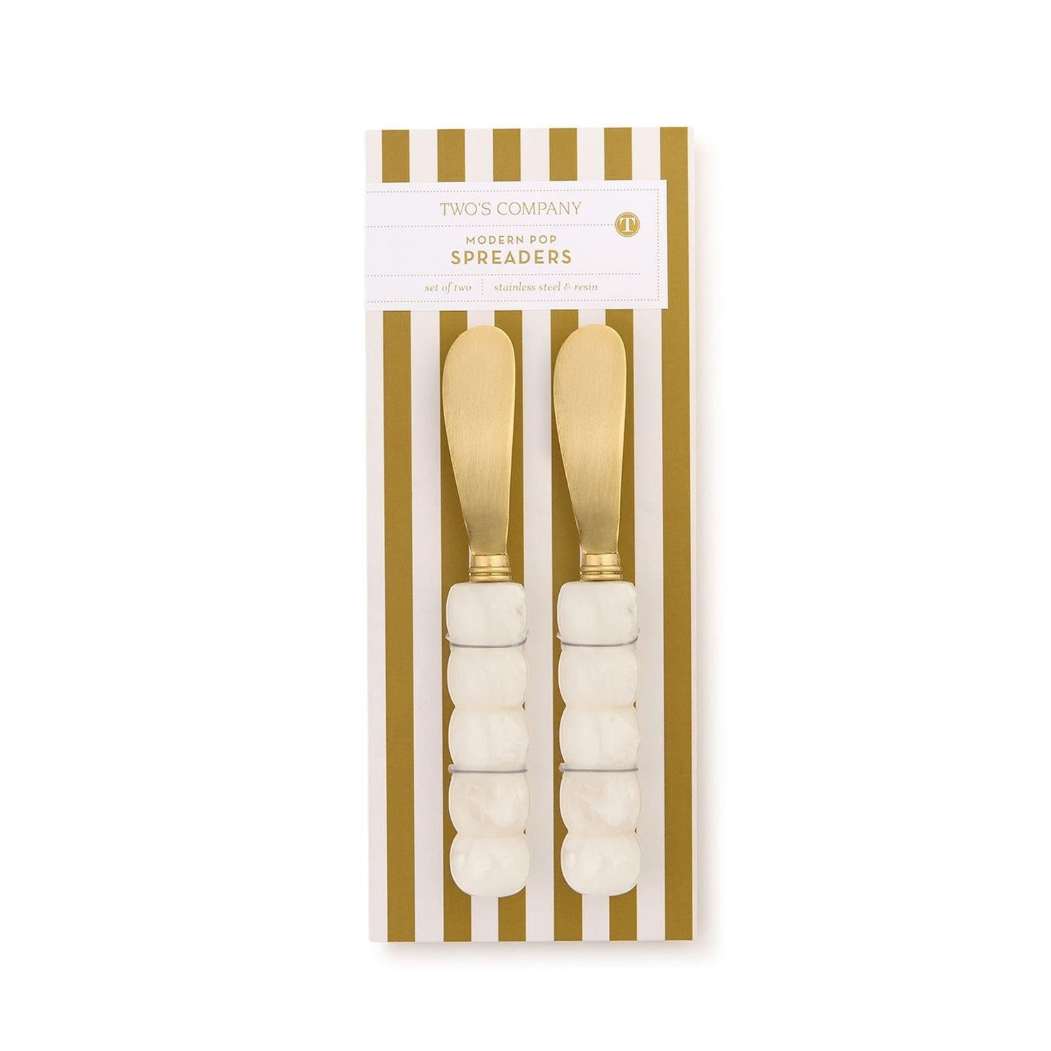 Product photography of Two's Company Modern Pop Spreaders featuring a pair of gold-finished stainless steel knives with white marbled resin bubble-textured handles displayed on a gold and white striped card