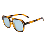 Product photograph of aviator style sunglasses featuring a brown tortoiseshell frame, light blue lenses, and 'Monaco' branding with gold A32-1 accents