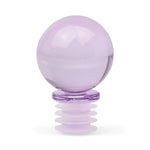 Translucent lavender glass sphere bottle stopper with a ribbed silicone base on a white background