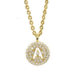Gold pavé disc necklace with a cutout initial A