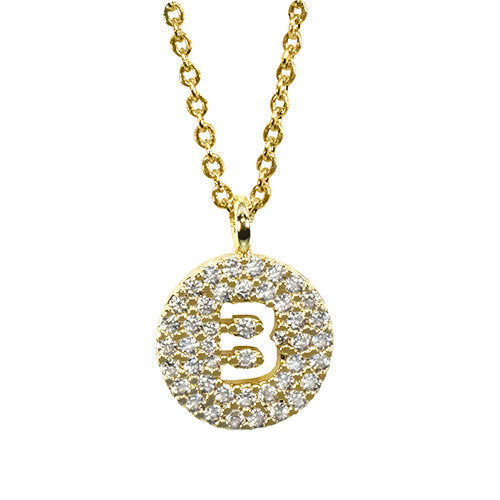 A sparkling gold chain necklace featuring a circular pendant adorned with numerous clear gemstones, centering a polished gold capital letter B