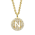 Gold pavé disc necklace with a cutout initial N