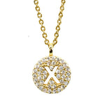 Gold pavé disc necklace with a cutout initial X