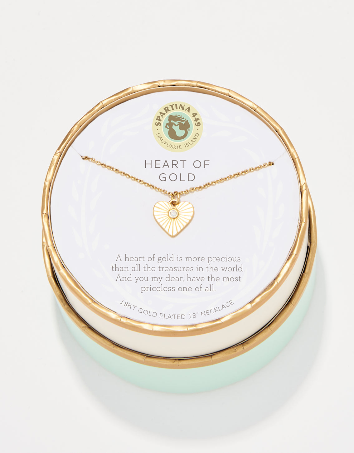 Spartina 449 18kt gold plated necklace from Daufuskie Island featuring a white enamel heart pendant with a central clear gem, presented in a round gold and mint green box with Heart of Gold text