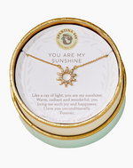 Spartina 449 Daufuskie Island 18KT gold plated necklace with a You Are My Sunshine message, featuring a crystal-studded sunburst pendant displayed on an inspirational card within a round mint green and gold gift box