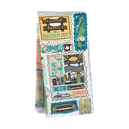 Tea towel with New Orleans themed illustrations including bridges, streetcars, and text