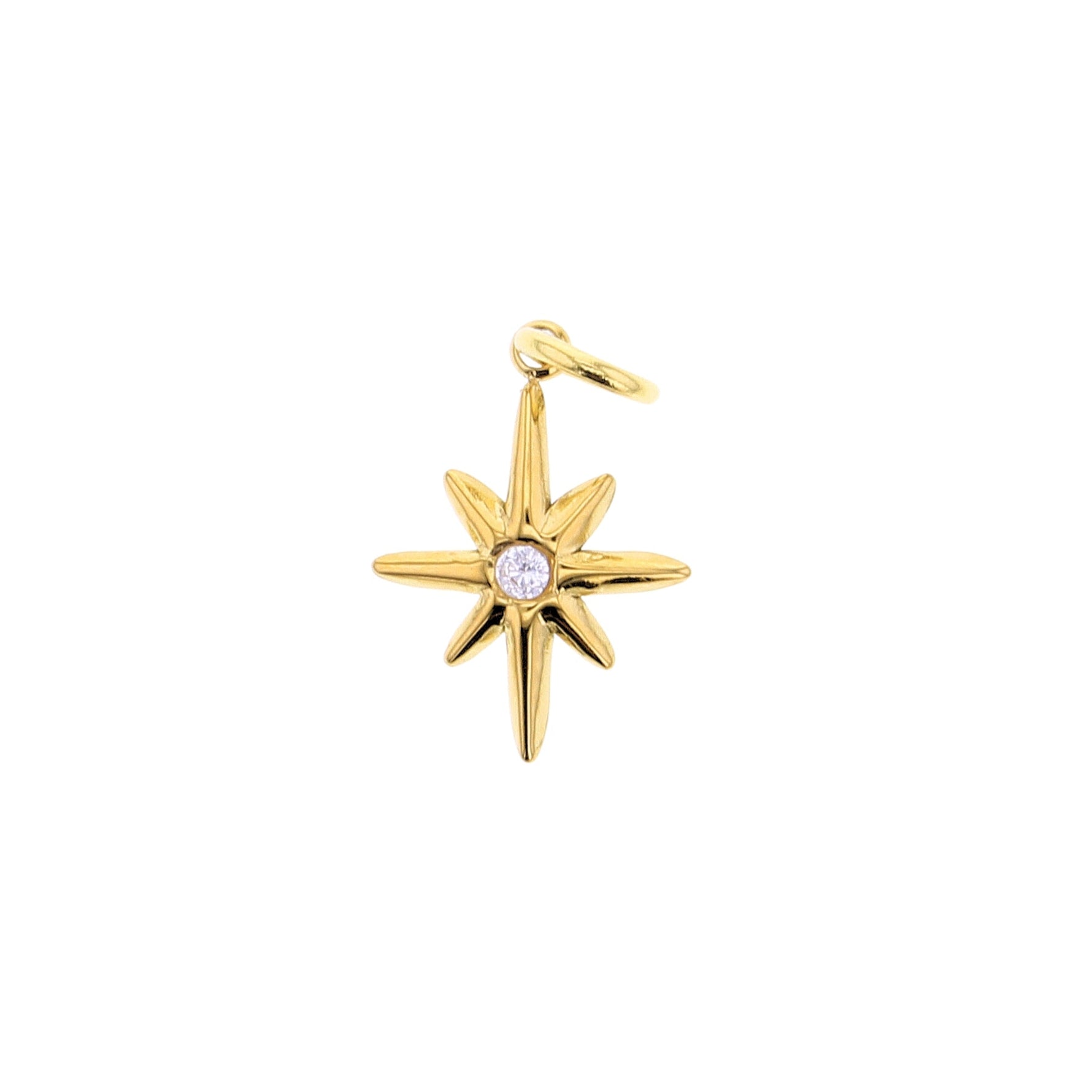 Gold charm featuring an eight-point North Star design with a brilliant round diamond center and a polished finish
