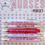Product packaging of a five-piece Nurses Pen Set featuring white, pink, and red pens with gold accents, each inscribed with humorous phrases like BEST FREAKING NURSE EVER and CAN'T FIX STUPID BUT WE CAN SEDATE IT on a background patterned with pink crosses and a nurse's cap illustration