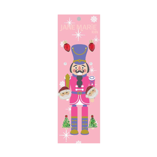 Digital illustration by JANE MARIE kids of a vibrant pink and purple Nutcracker adorned with red Christmas light bulb earrings, Santa Claus heads, and glittery green Christmas trees against a sparkling pink background
